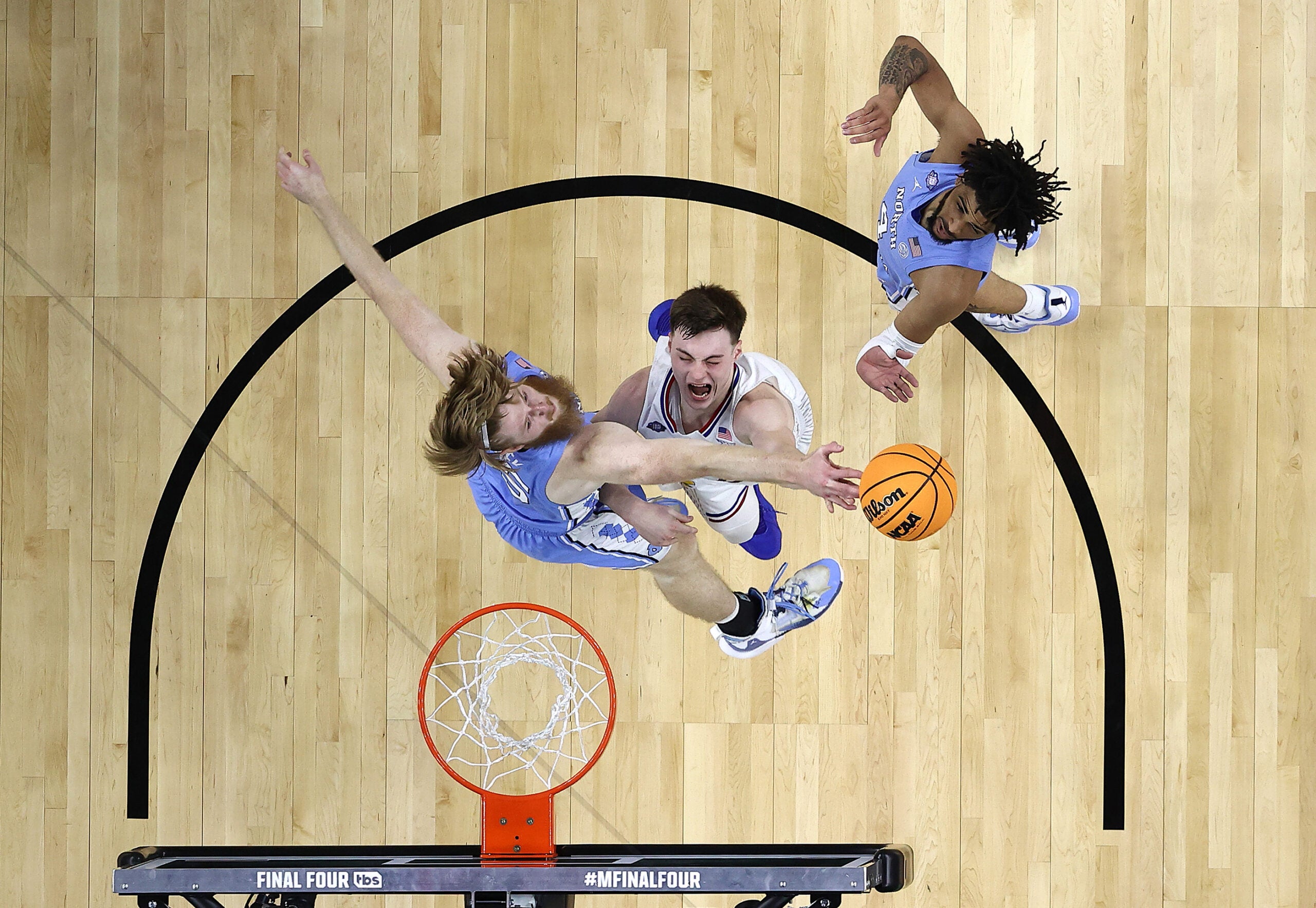 Brady Manek #45 of the North Carolina Tar Heels blocks a shot by Christian Braun #2 of the Kansas Jayhawks in the first half of the game during the 2022 NCAA Men's Basketball Tournament National Championship.