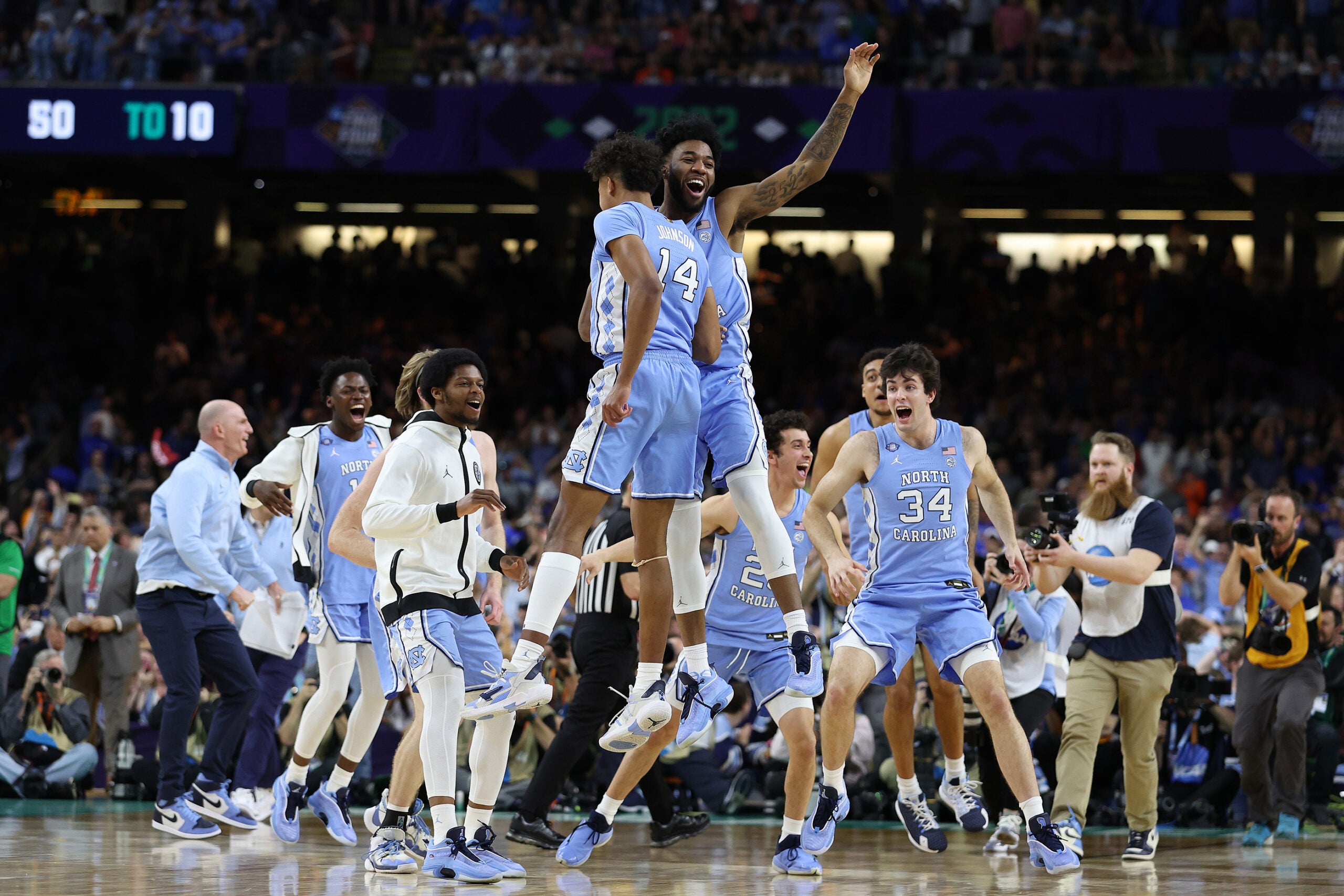 Puff Johnson #14 and Dontrez Styles #3 of the North Carolina Tar Heels react after defeating the Duke Blue Devils 81-77 in the second half of the game during the 2022 NCAA Men's Basketball Tournament Final Four semifinal.