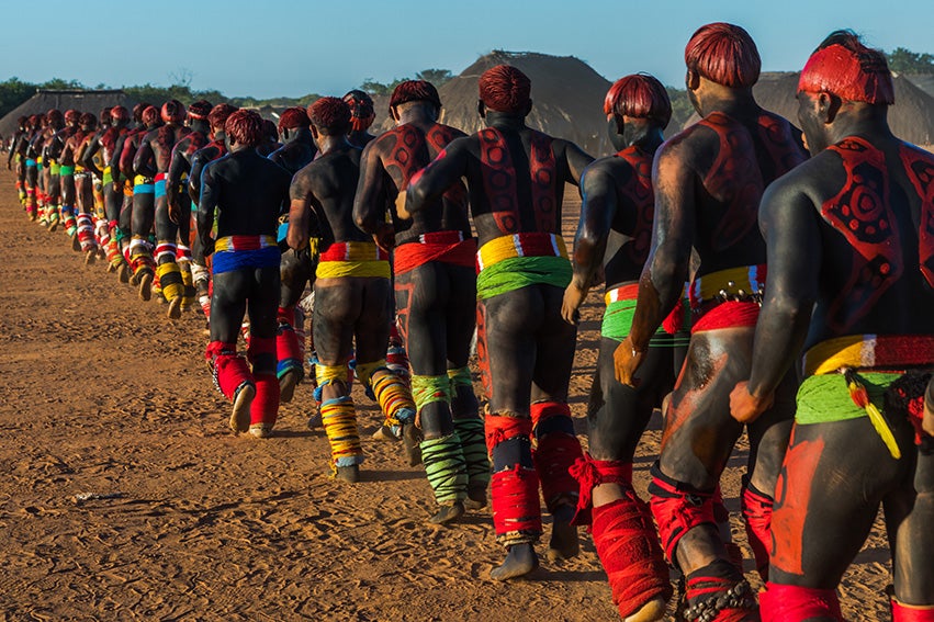 brazilian men dressed in traditional garb prepare for competition 