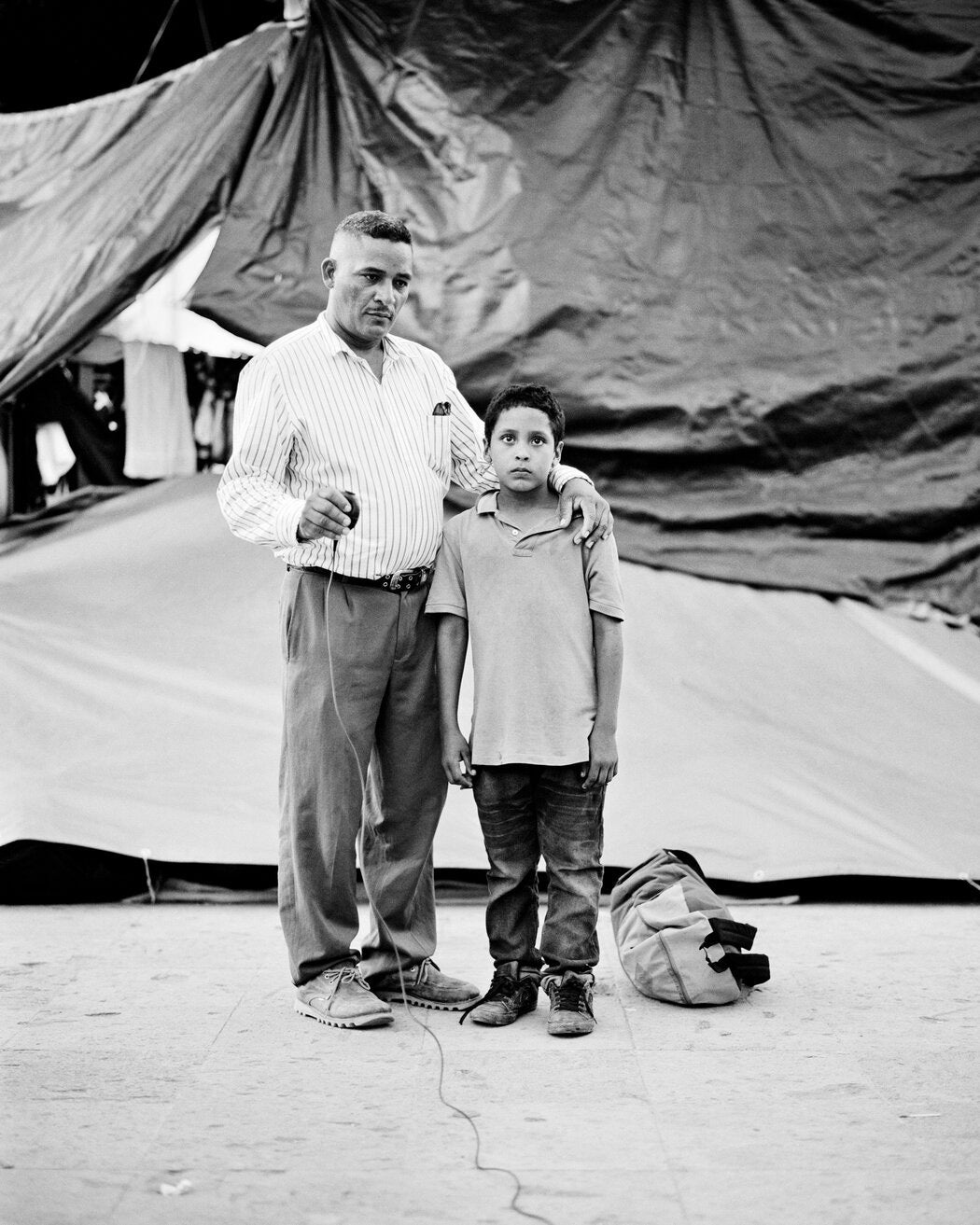 A black and white portrait of a migrant girl on the US Mexico border