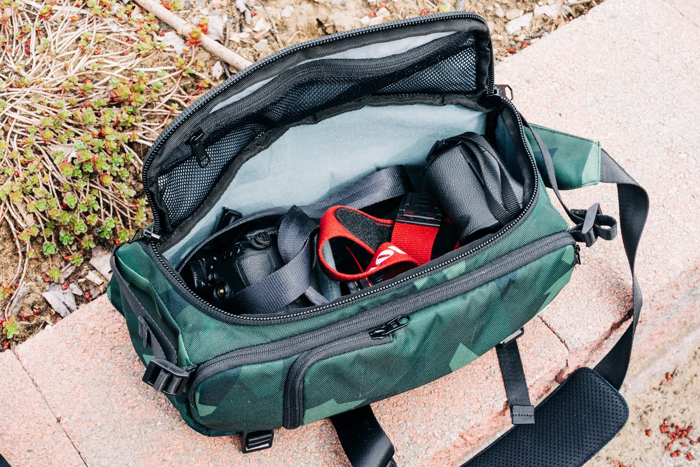 Hex Sling V2 camera bag on a rock wall