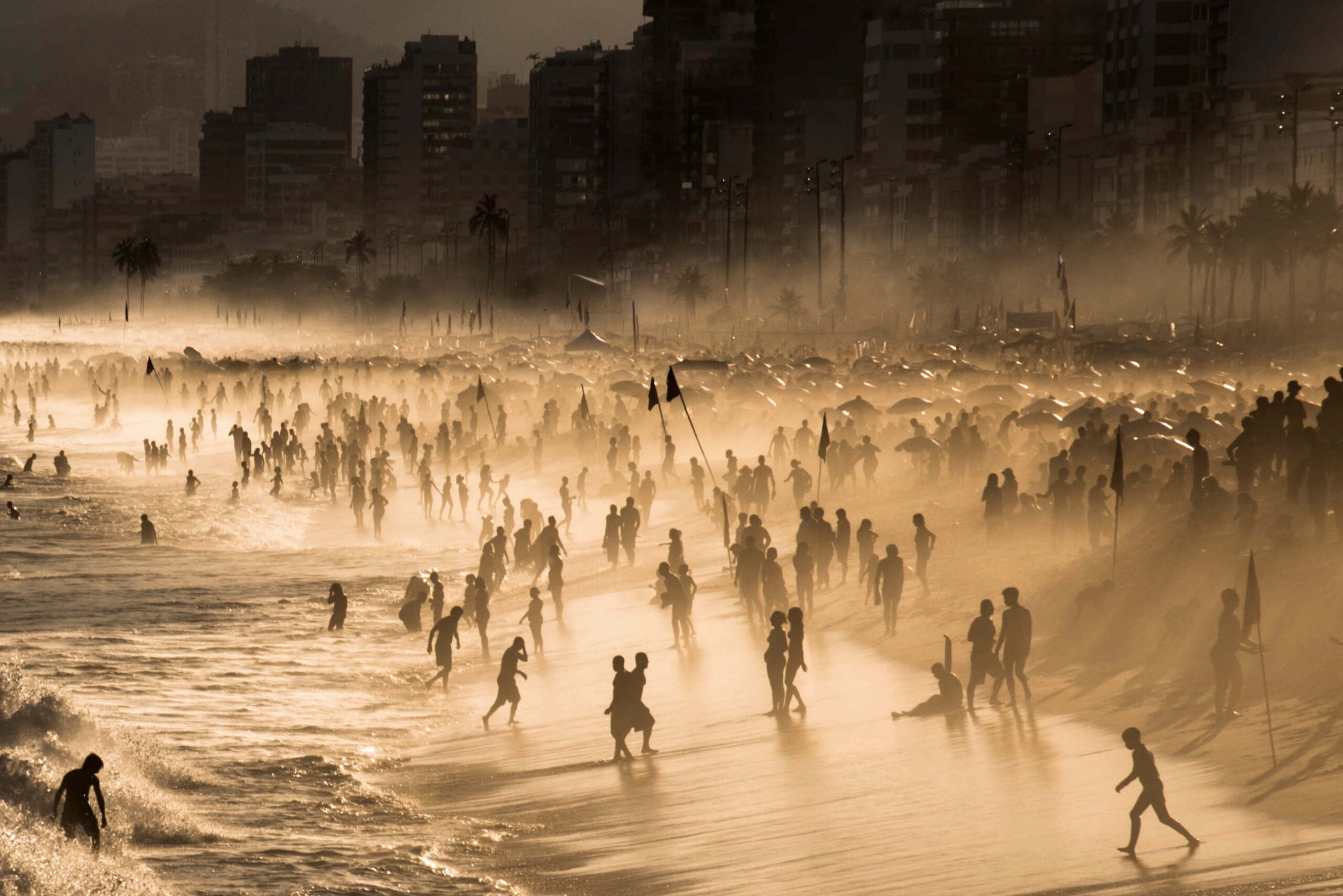 silhouettes of beachgoers at sunset in Brazil
