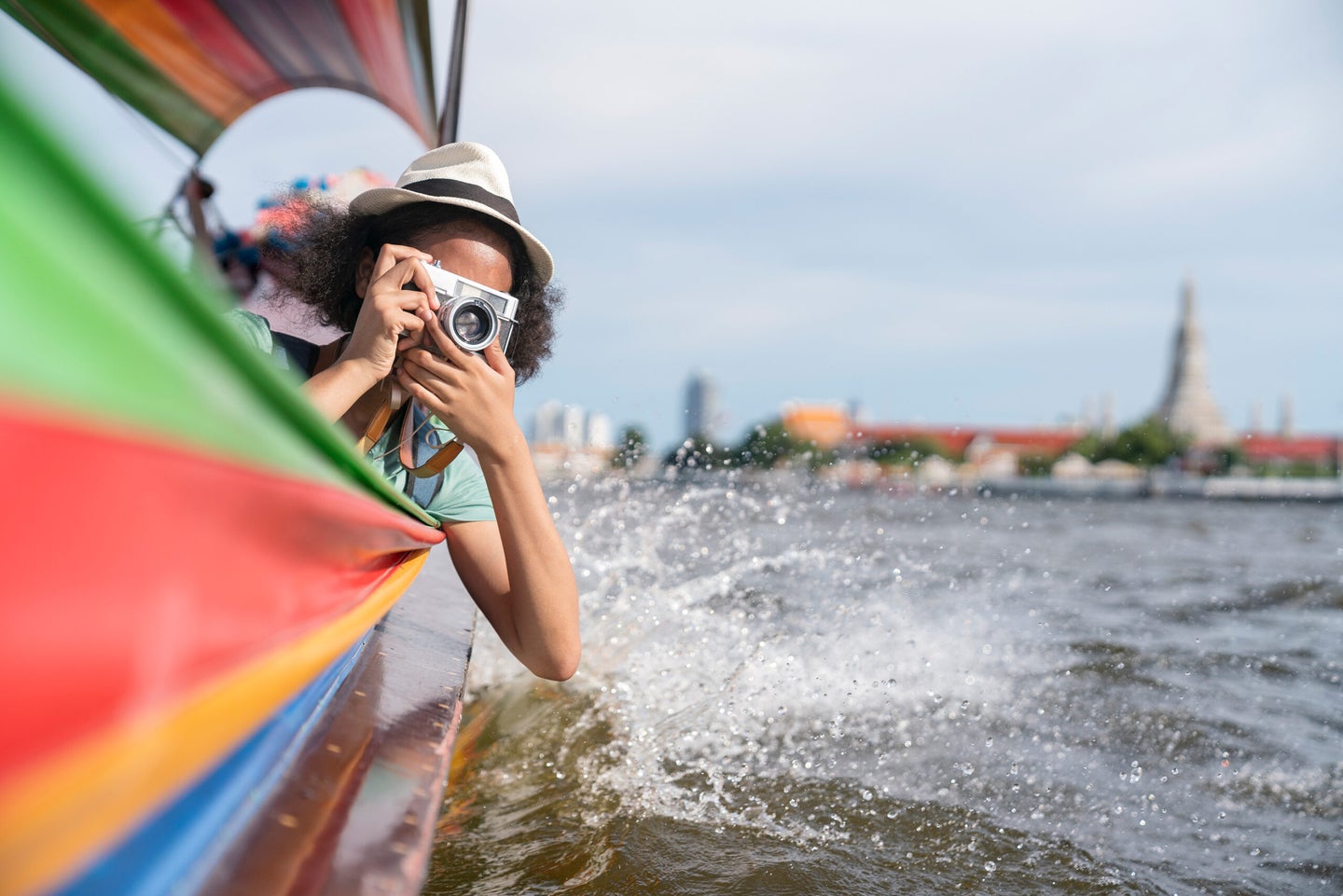 Woman in longtail boat take photo Chao Phraya River in Bangkok.