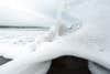 Foamy waves crash on a rock. Sony a7IV sample photo.