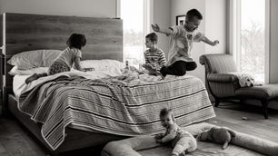 boy jumps off bed. how to photograph kids