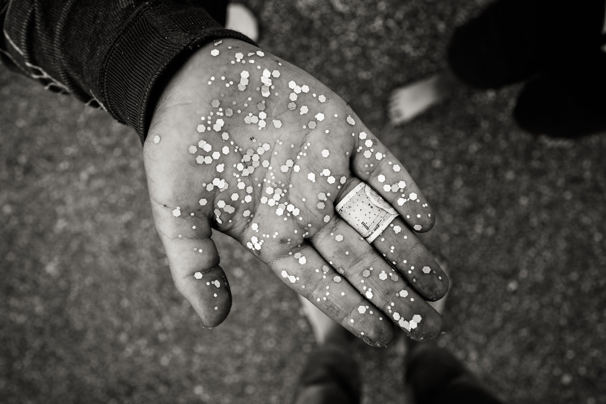 child's hand full of glitter.  how to take pictures of children