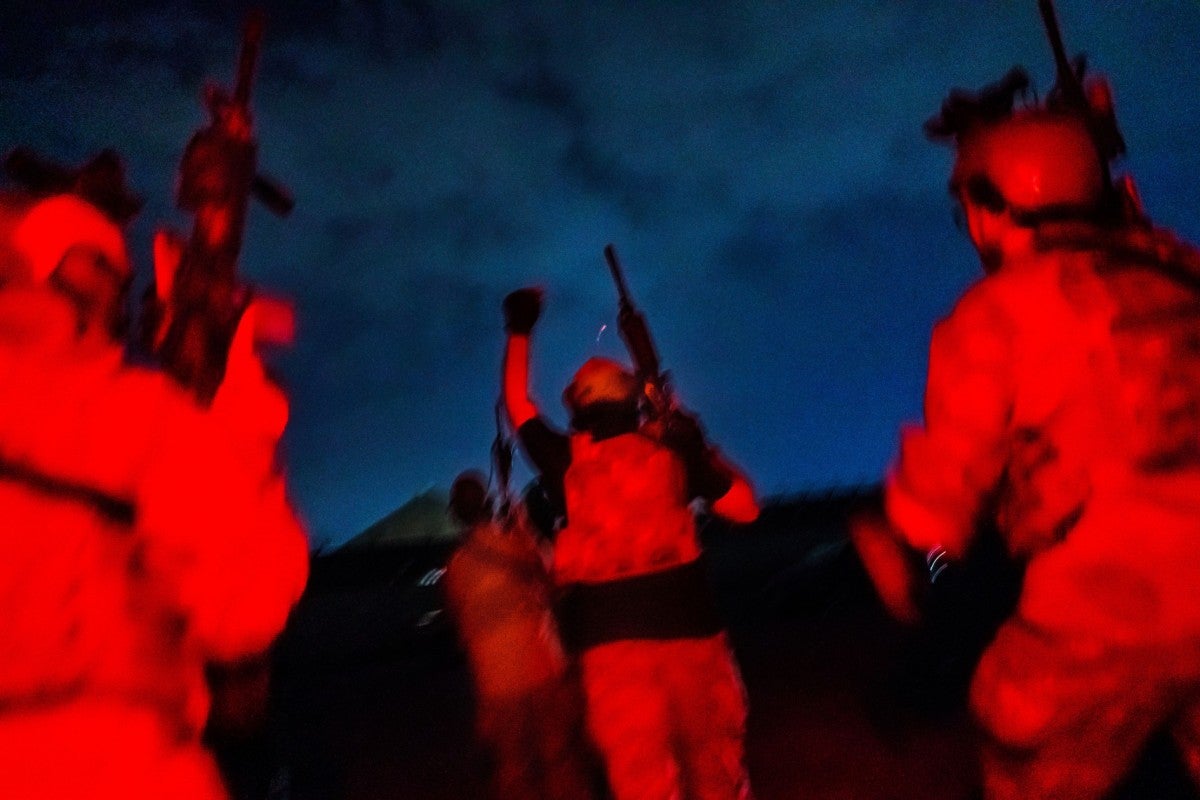 After the stroke of midnight, Taliban fighters from the Fateh Zwak unit storm into Hamid Karzai International Airport, while wearing American-made uniforms and brandishing American M4 and M16 rifles and riding U.S. pickup trucks on Aug. 31, 2021.