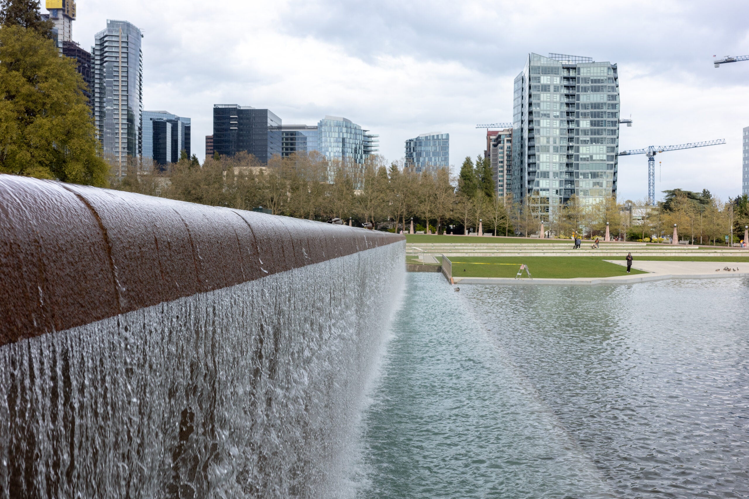 A fountain with a skyline in the background