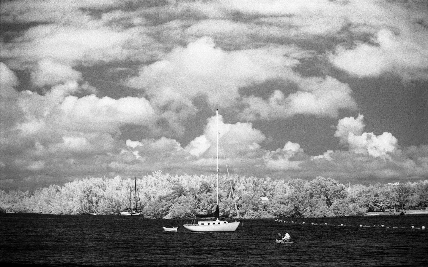 lone ship out on a lake on a cloudy day