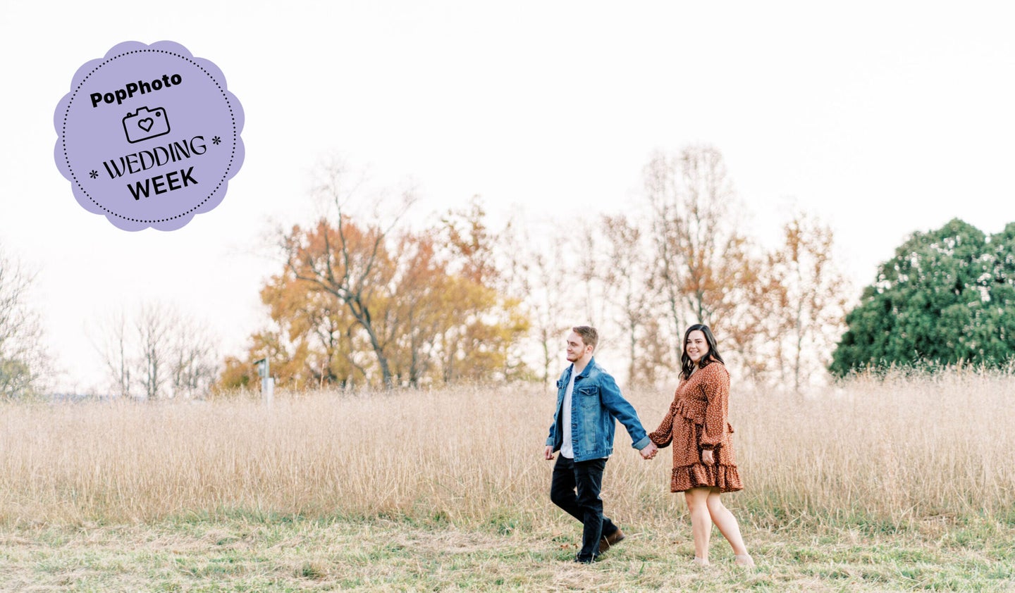 A happy couple holding hands in a field