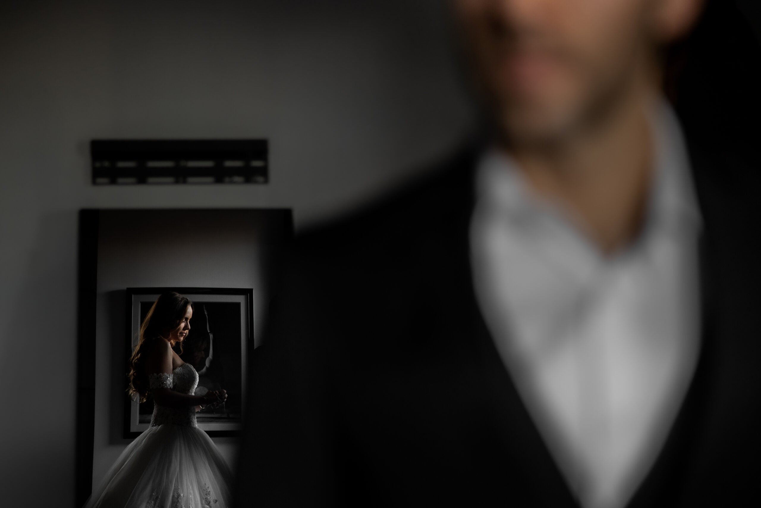 Bride in the mirror, groom out of focus.