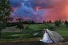 A bride and groom with a stunning sunset behind them.