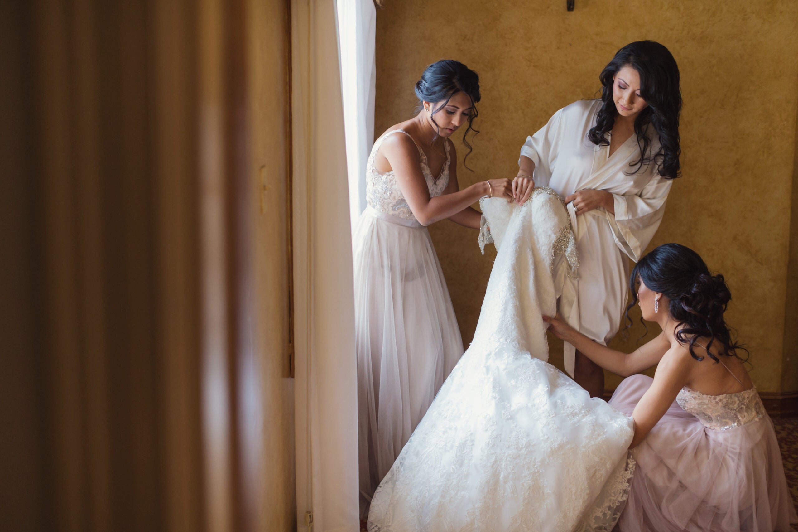Bridesmaids help a bride.