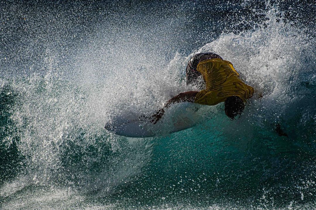 Surfer cutting through a wave.