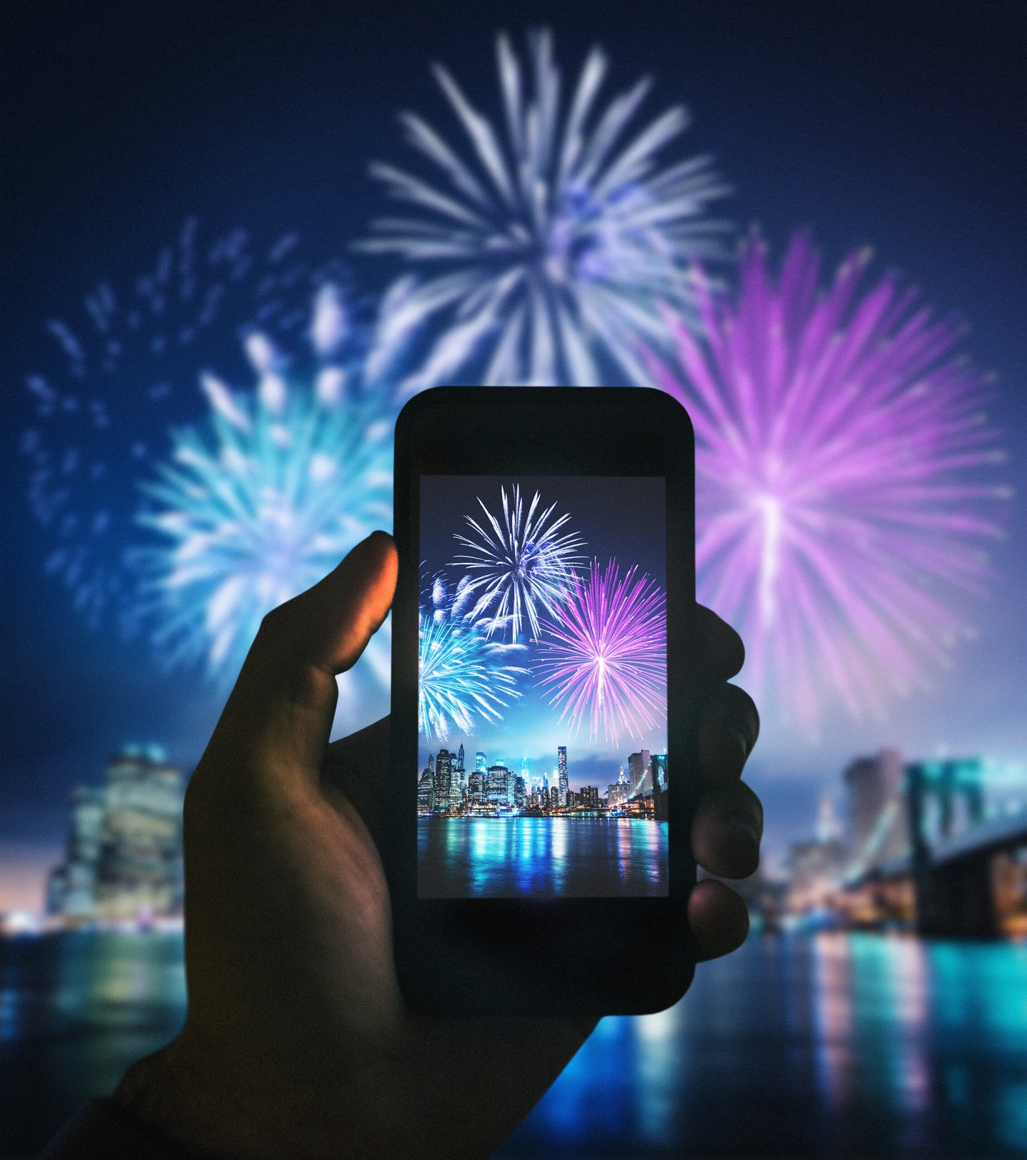 Smartphone in hand shooting firework photos