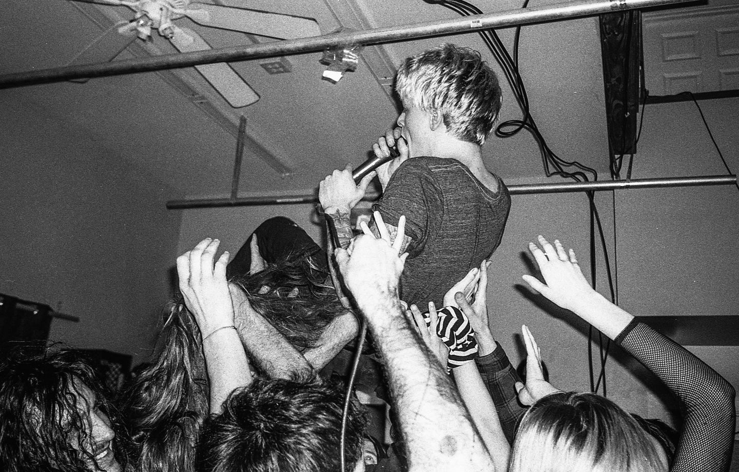 A crowd surfing musician, shot on Ilford HP5 Plus.