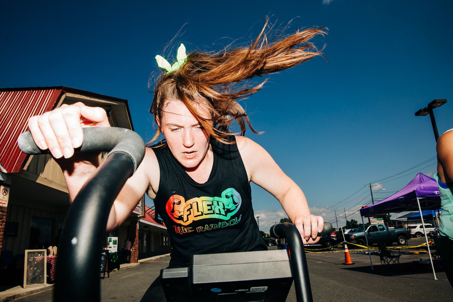 A women rides a bike in bright daylight