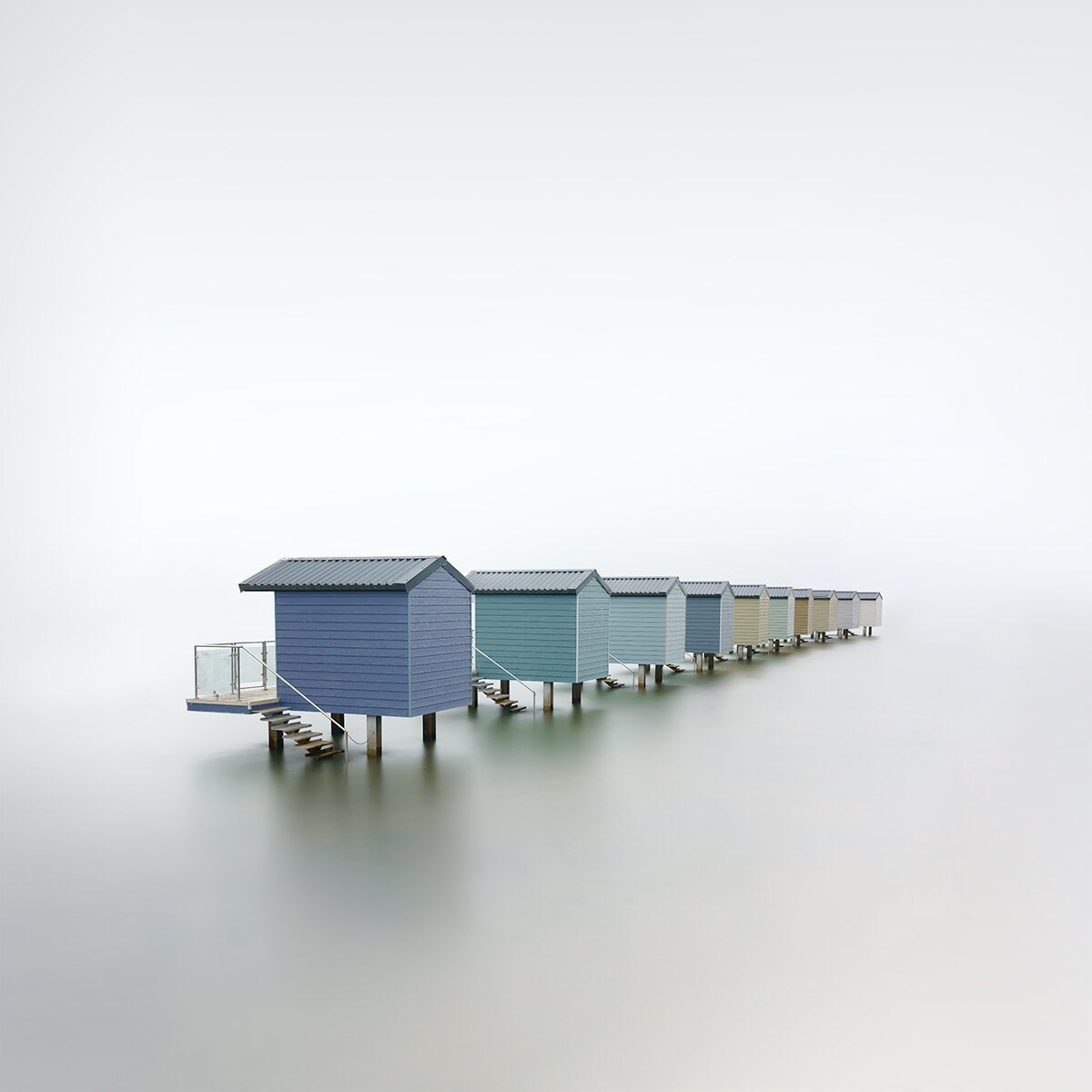 huts on a lake in the fog