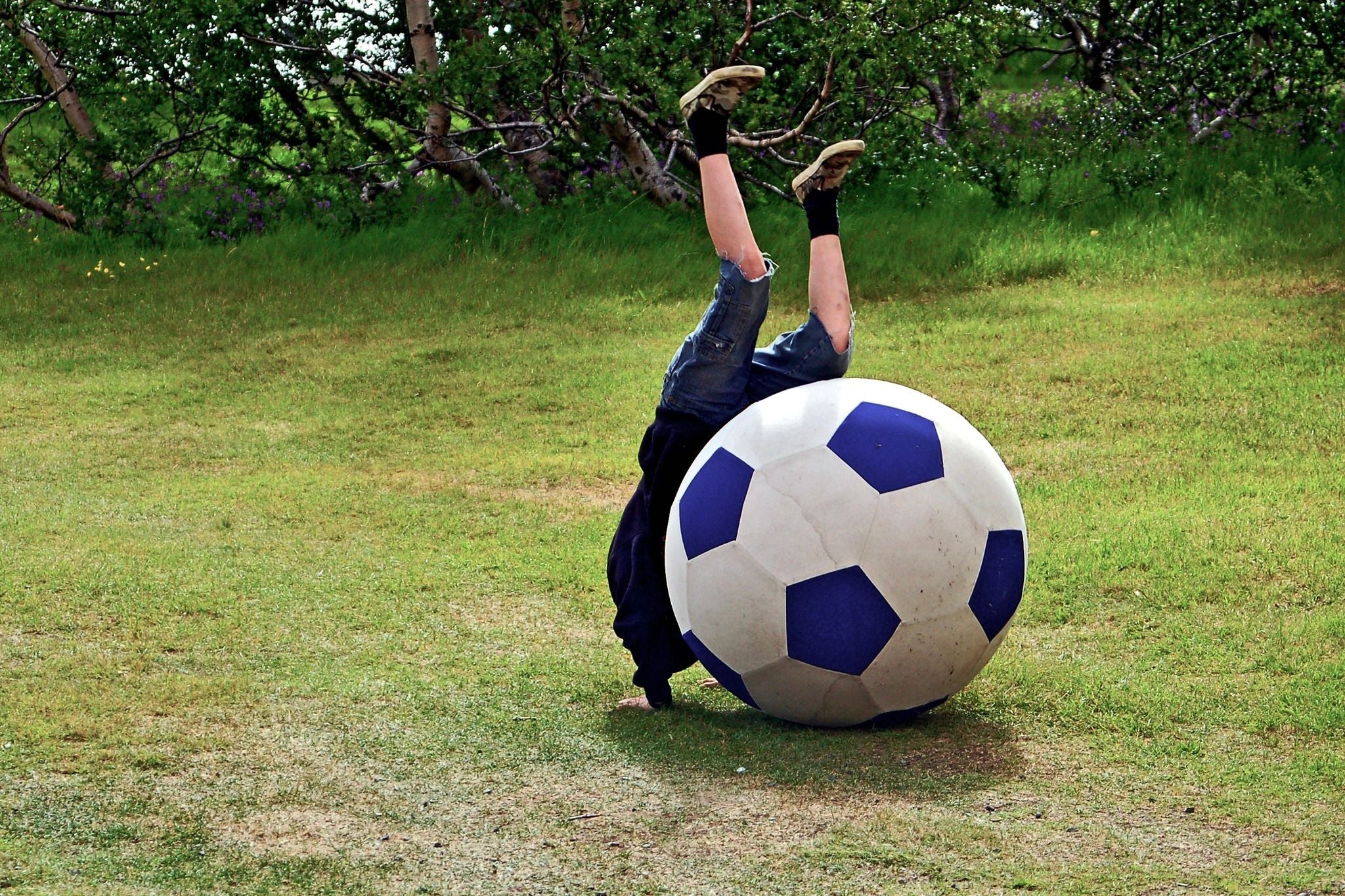 boy playing with giant soccer ball