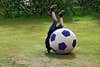 boy playing with giant soccer ball