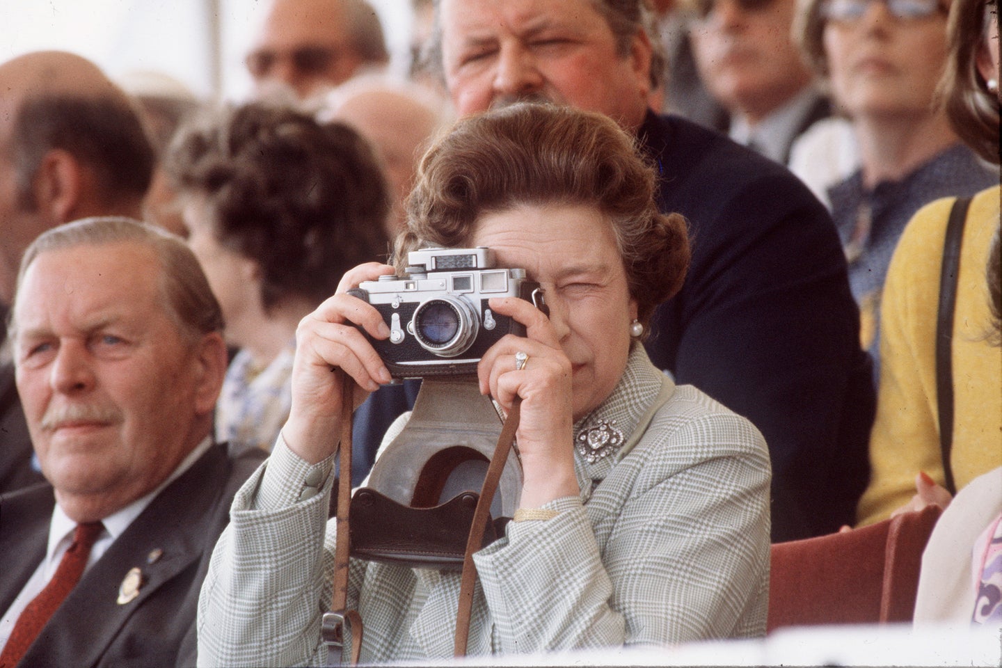 The queen taking a picture at the Royal Windsor Horse Show.
