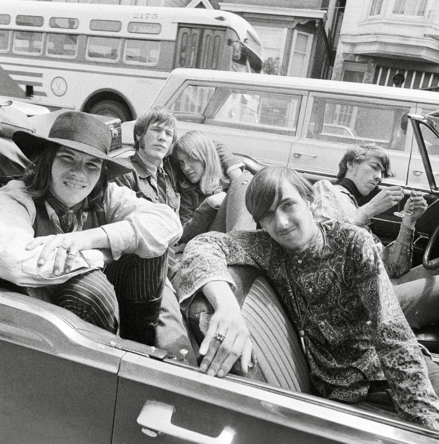 A B&W photo of a convertible full of youths in 1968.