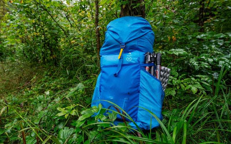 Blue Moment Strohl Mountain Light 45L hiking camera backpack in a forest