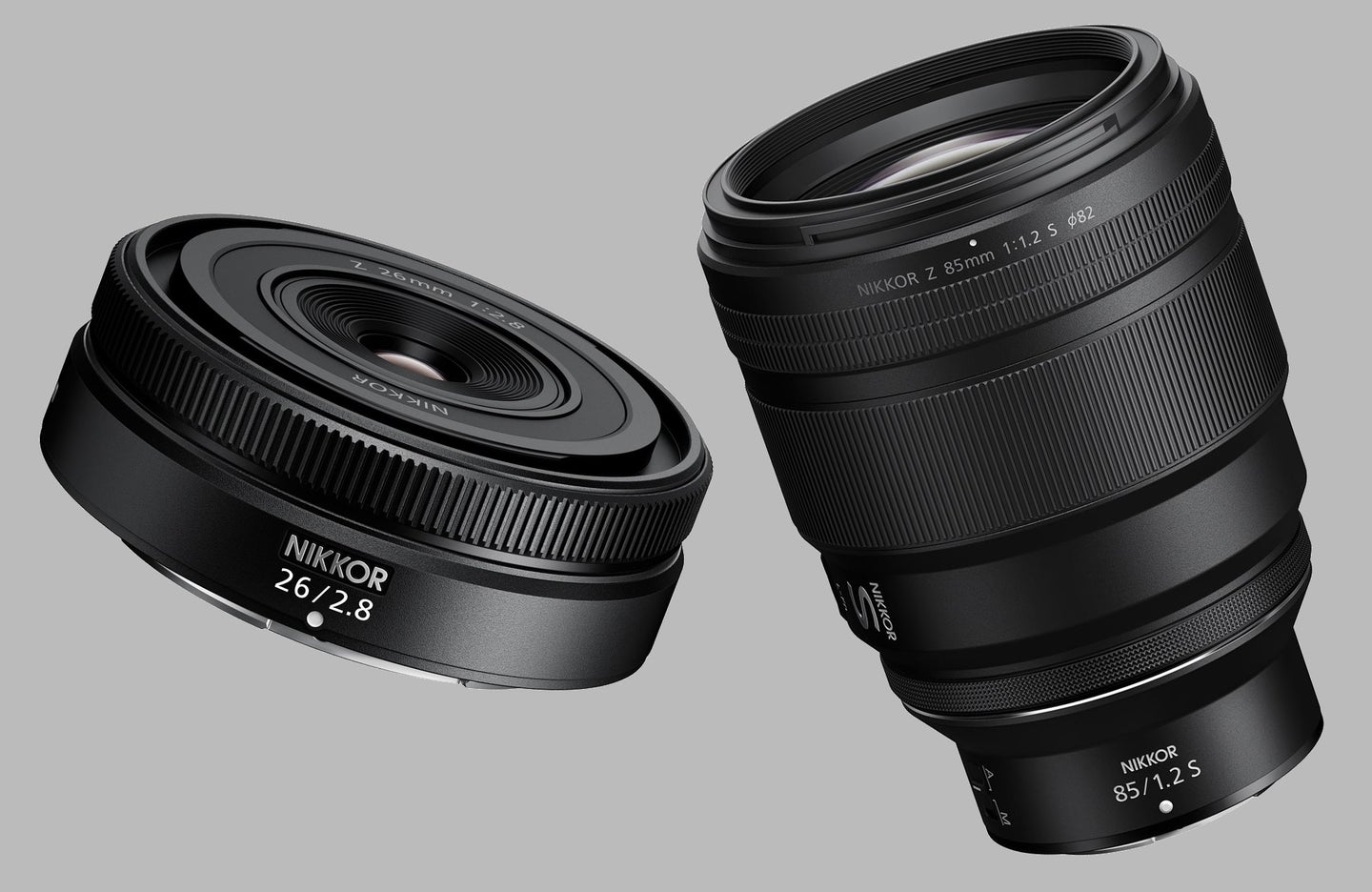 Nikon Z 85mm f/1.2 and Z 26mm f/2.8 lenses on gray