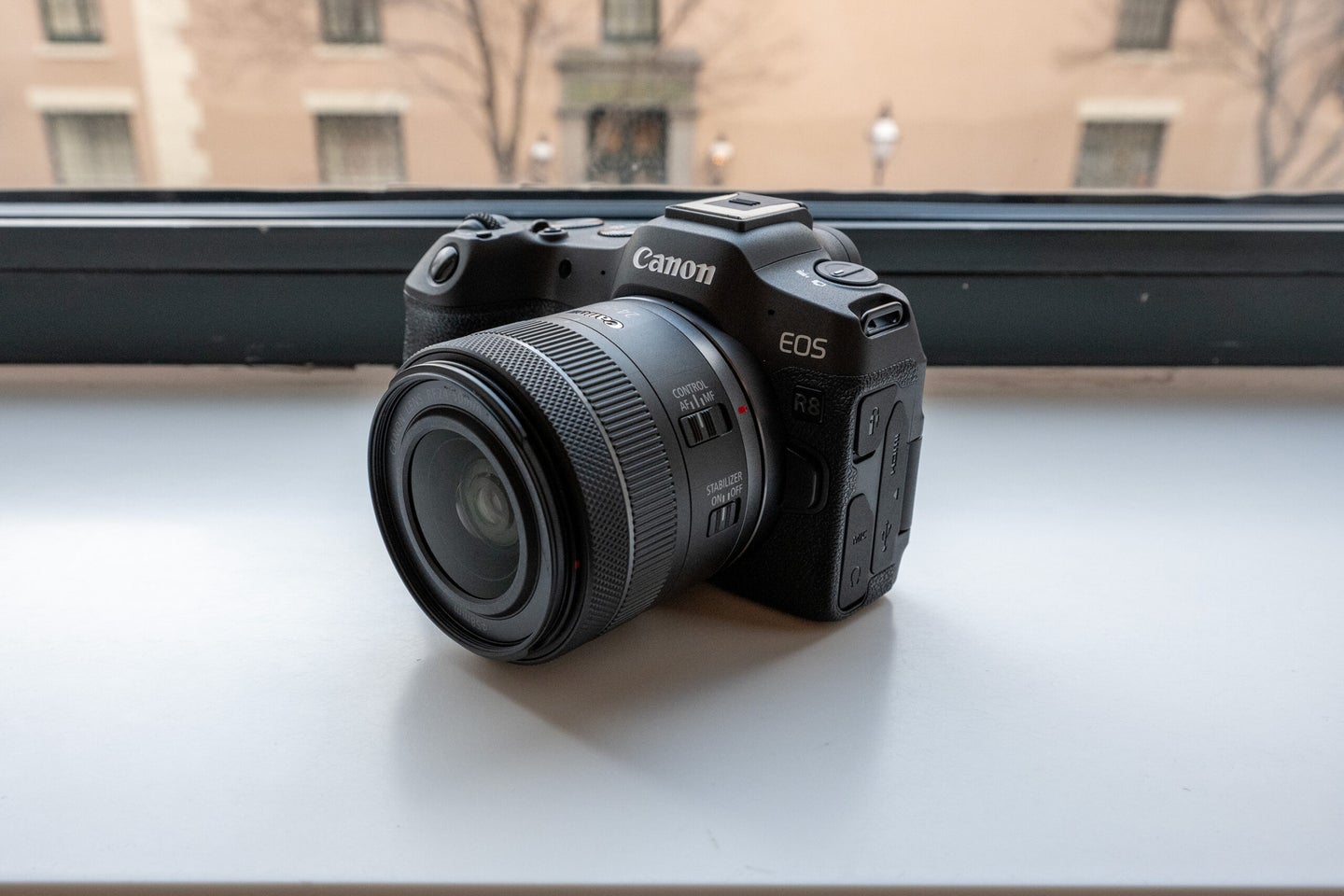 Canon EOS R8 mirrorless camera on a windowsill