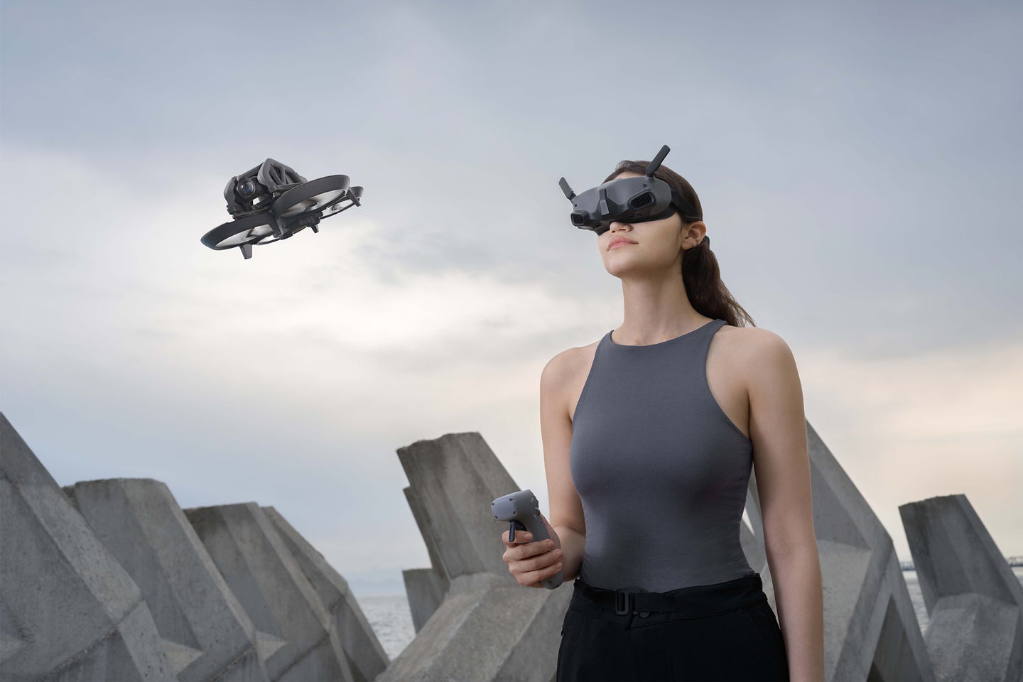 A woman flies the DJI Avata drone with the Goggles Integra and RC Motion 2