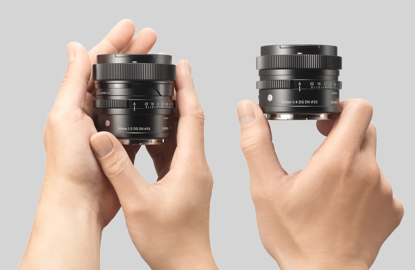 Sigma I series prime lenses 50mm f/2 and 17mm f/4 in hands