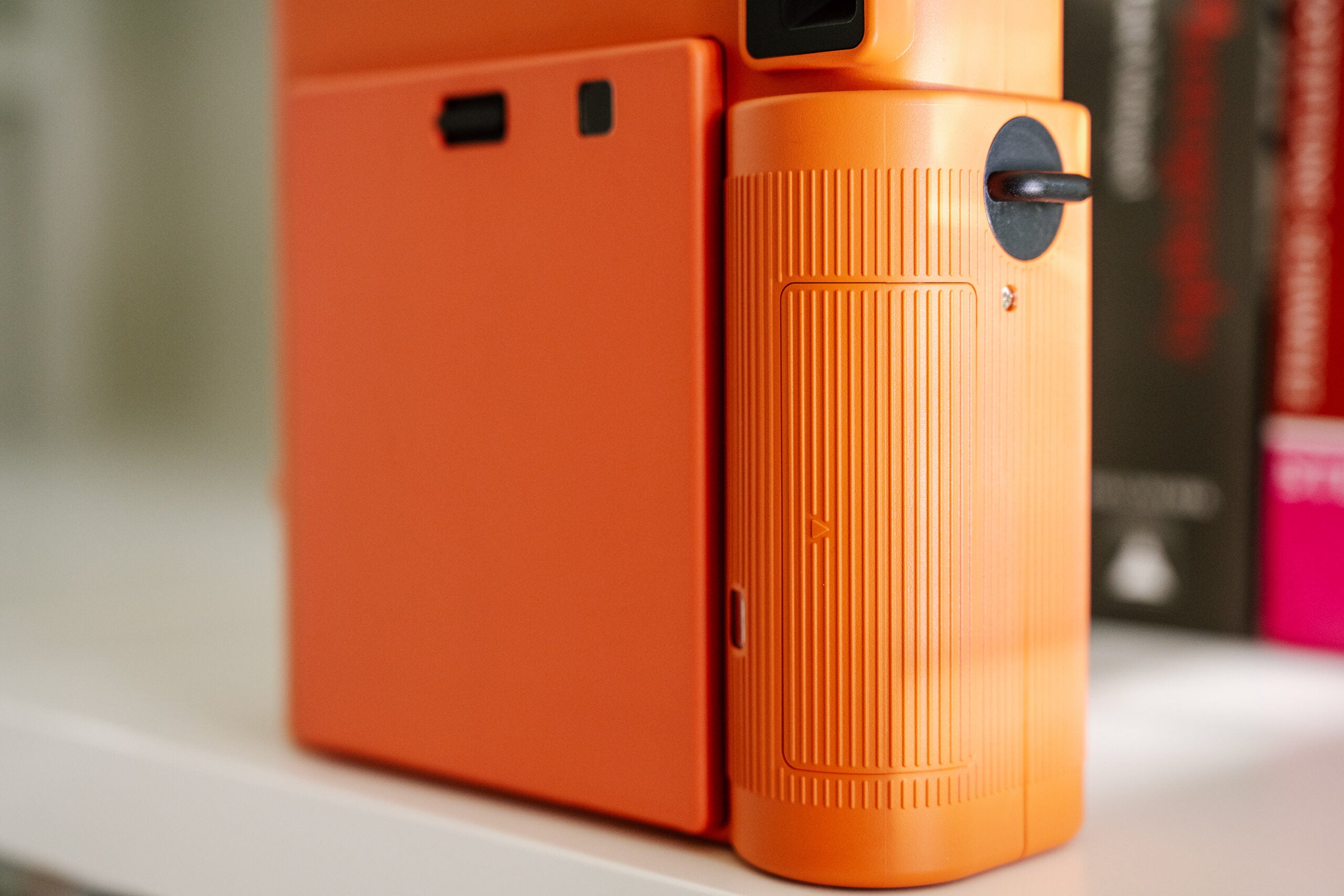 Texturized side of the Terracotta Orange Instax Square SQ1 instant camera