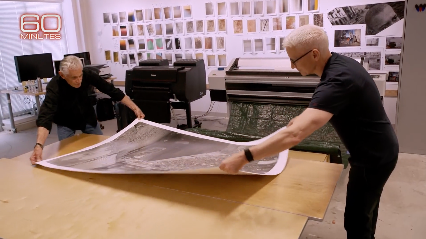 James Nachtwey and Anderson Cooper in Nachtwey's studio holding a print