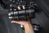 The Laowa Ranger 28-75mm in a hand.