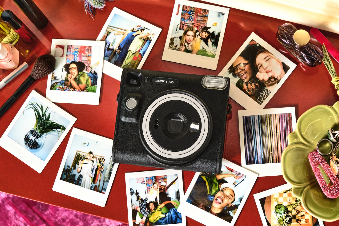 Fujifilm Instax SQ40 instant film camera surrounded by prints