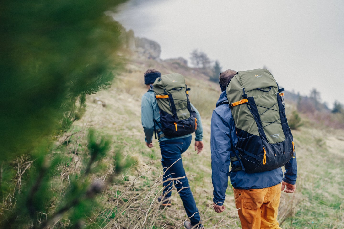 Two hikers wearing Lowepro PhotoSport X camera backpacks
