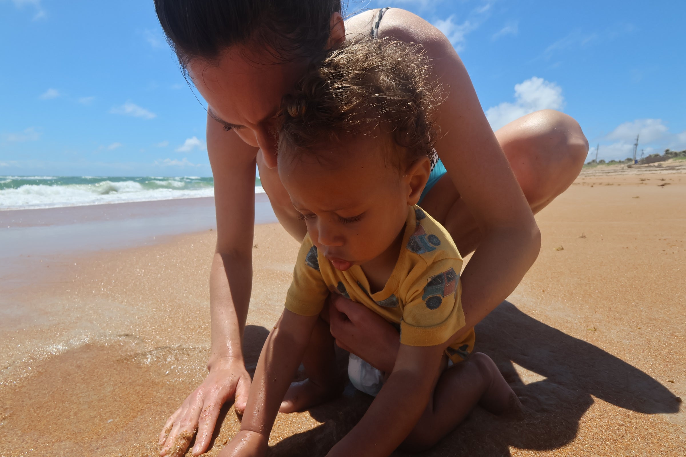 A little boy and his mom at the beach