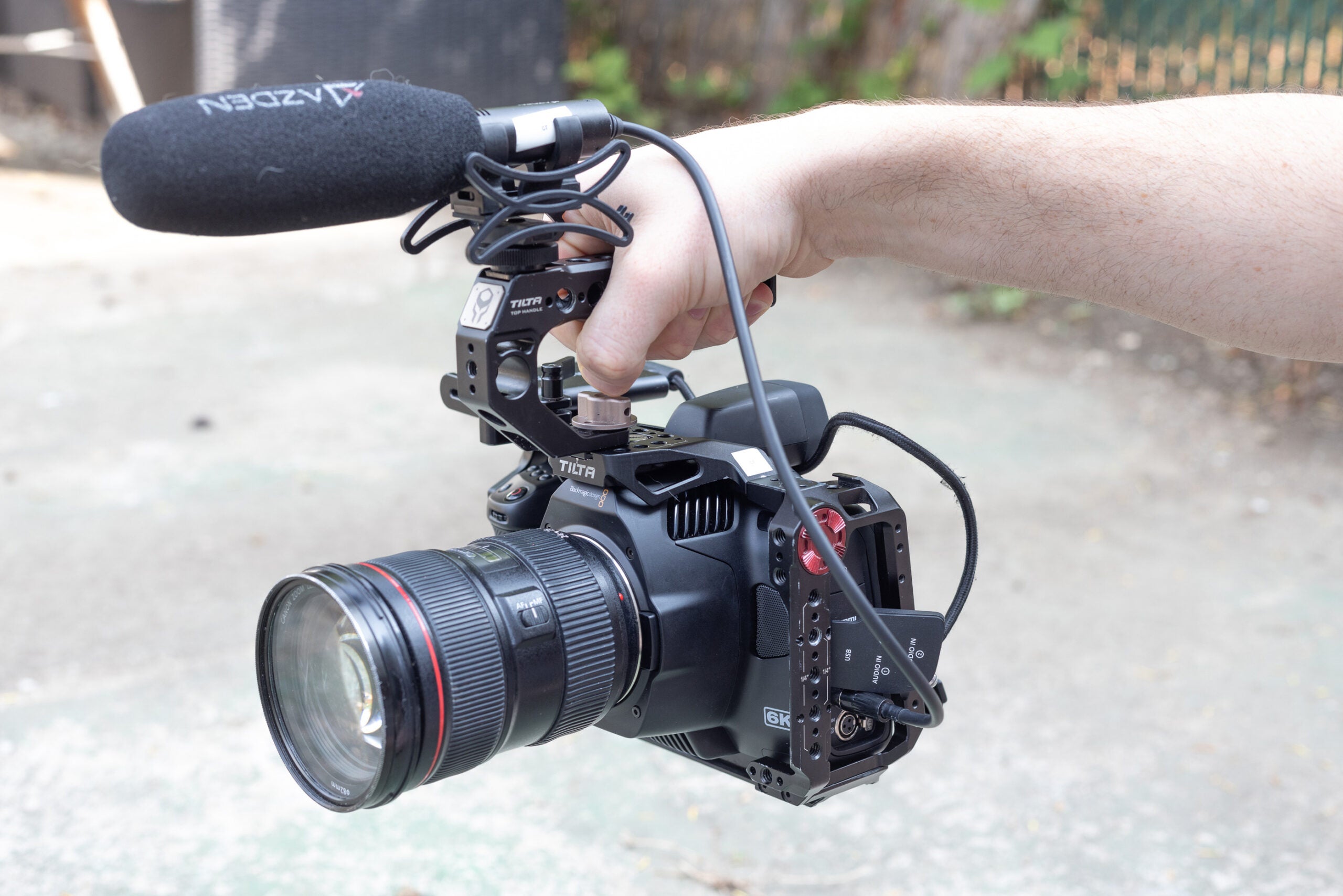 A Blackmagic Pocket Cinema Camera 6K G2 in a cage with mic