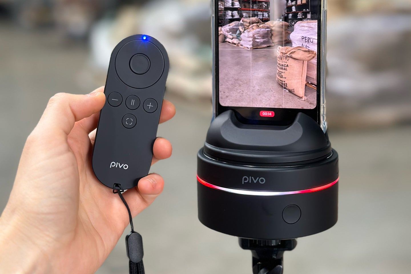 The Pivo Max and Pivo Max remote in a hand