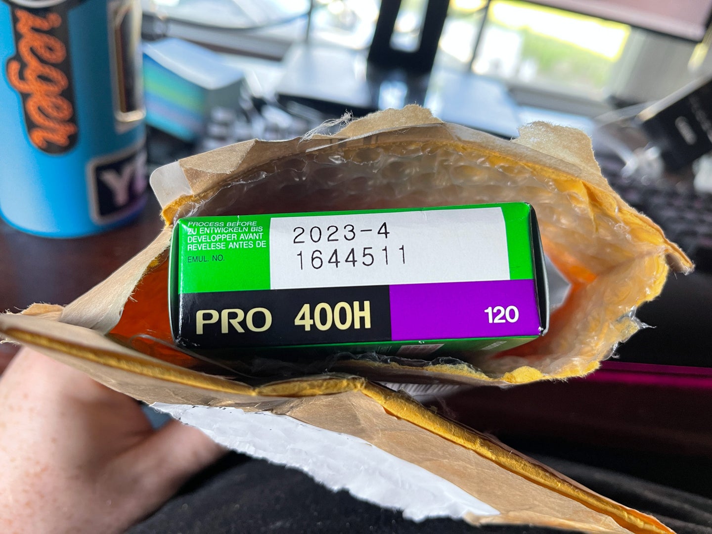 A package ripped open to show a box of film inside