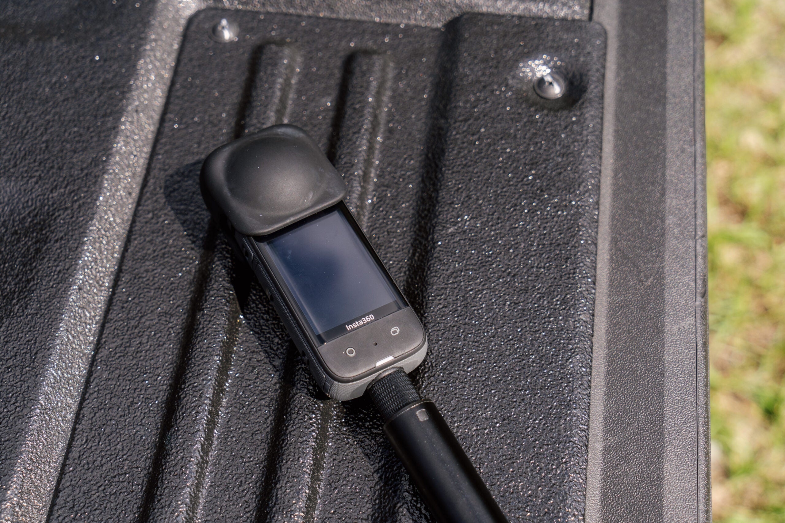 The X3 on a truck tailgate with the lens cap on.