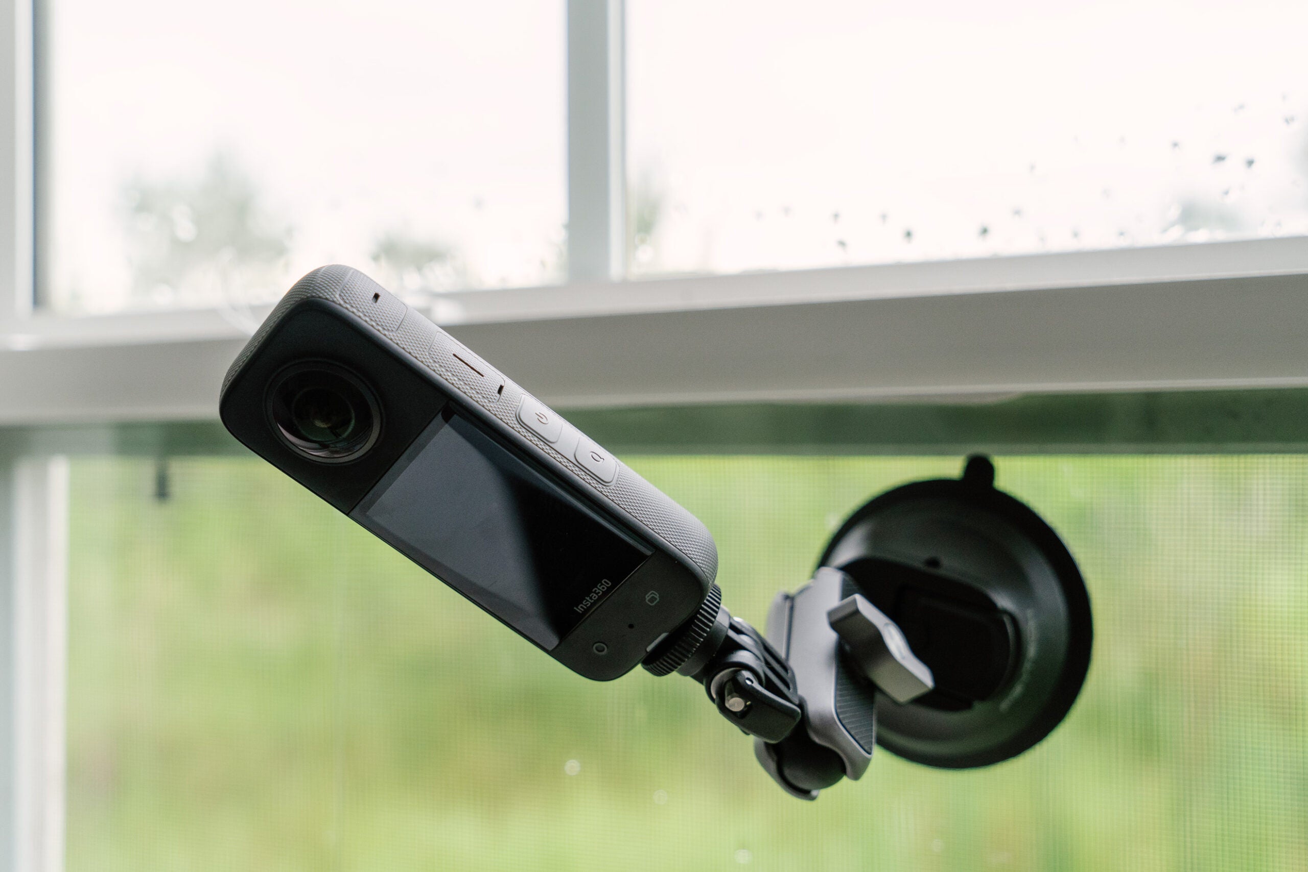 The Insta360 X3 on a window using the suction cup mount