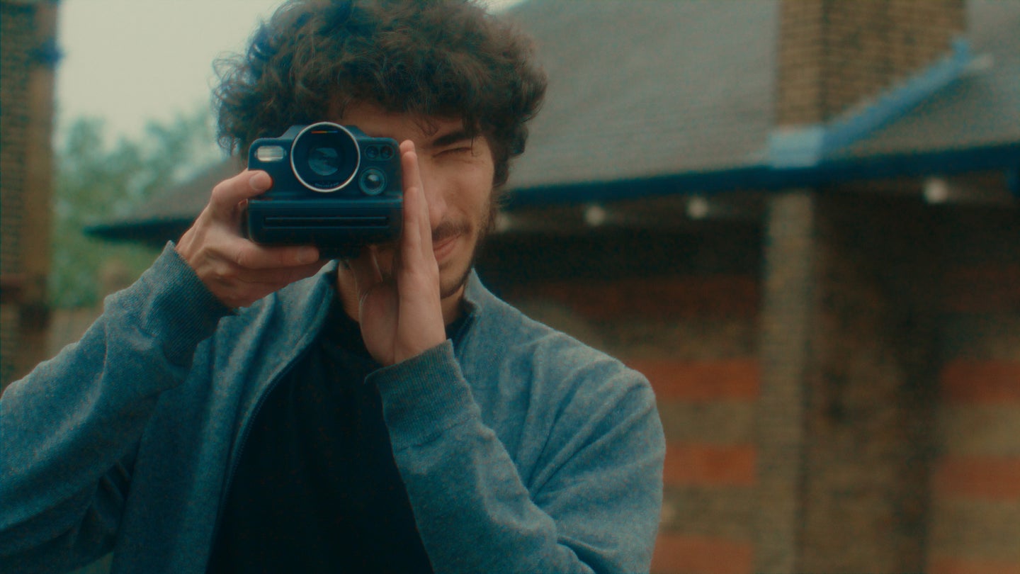 The Polaroid CEO, Oskar Smolokowski, holds the Polaroid I-2 in front of his face.